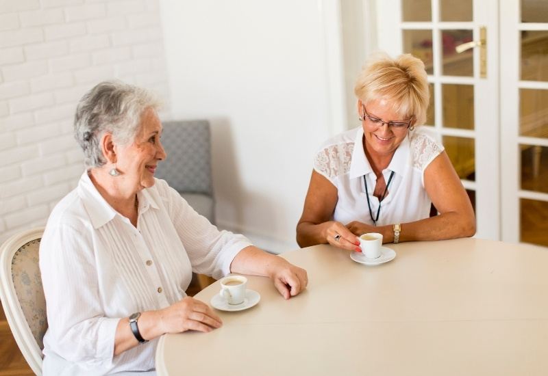 Two women talking over coffee at home
