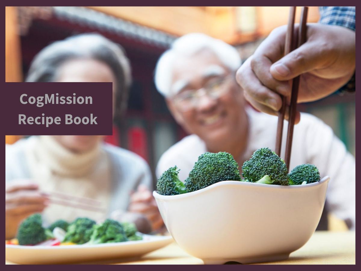 CogMission Recipe Book cover showing smiling older couple sharing a bowl of broccoli with chopsticks