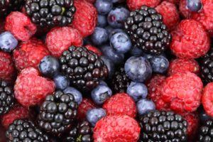 Close-up of fresh raspberries, blackberries and blueberries mixed together, rich in colourful phytonutrients