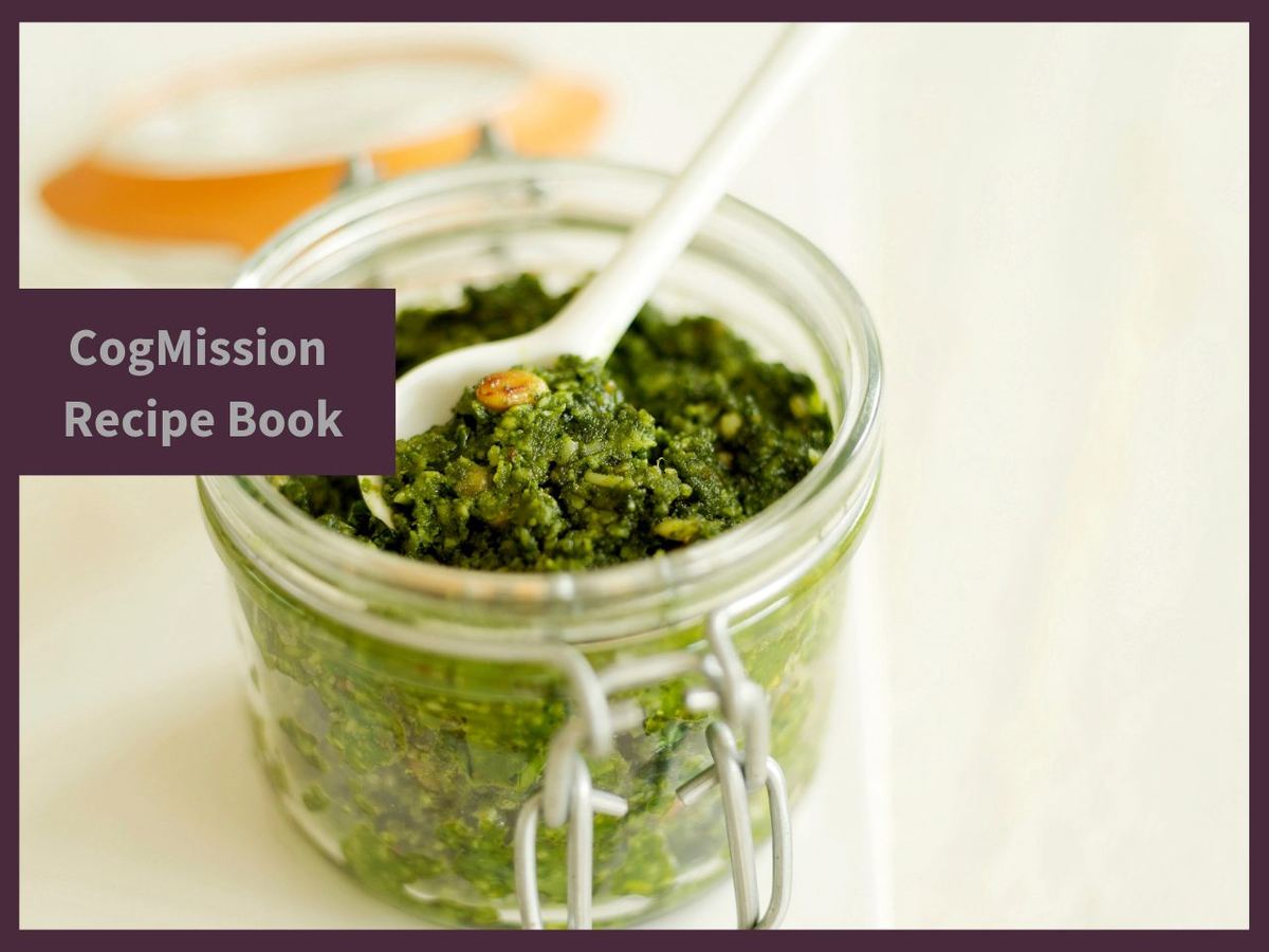 CogMission Recipe Book cover showing a glass jar of fresh green pesto with a white spoon